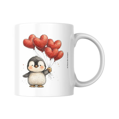 Mug en céramique blanc Saint-Valentin avec illustration d'un petit pingouin mignon tenant des ballons rouges en forme de cœur.